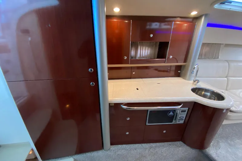 Slide: The Image of Luxurious 2006 Formula 400 Super Sport yacht interior with modern kitchenette and sleek cabinetry. - 19
