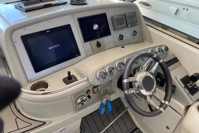 Slide: The Image of 2006 Formula 400 Super Sport boat dashboard with steering wheel and navigation screens. - 38