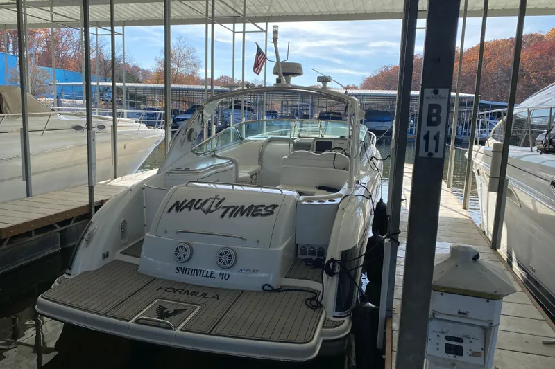 Slide: The Image of 2006 Formula 400 Super Sport boat docked at marina, named "Nauti Times," Smithville, MO. - 5