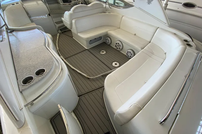 Slide: The Image of 2006 Formula 400 Super Sport boat interior with white seating and wood-style flooring. - 6