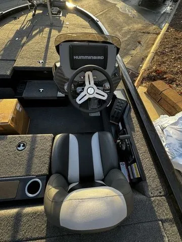 Slide: The Image of 2024 Vexus AVX2080 boat interior with steering wheel and seat, featuring Humminbird electronics. - 6