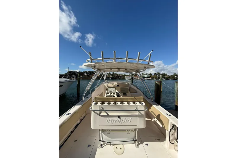 Slide: The Image of 2008 Intrepid 370 Cuddy boat docked, featuring spacious deck and powerful engines. - 17