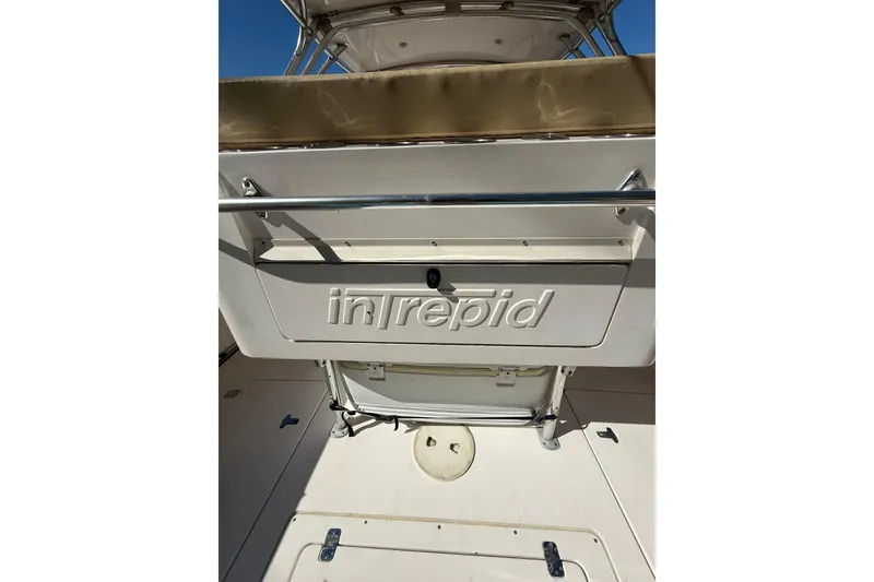 Slide: The Image of 2008 Intrepid 370 Cuddy boat with spacious cockpit and sleek design under blue sky. - 19