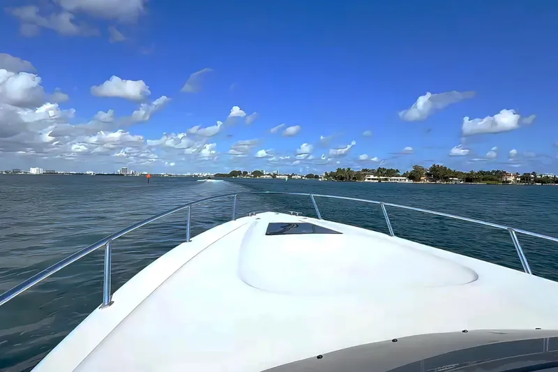 Slide: The Image of 2008 Intrepid 370 Cuddy boat docked in clear green water. - 2