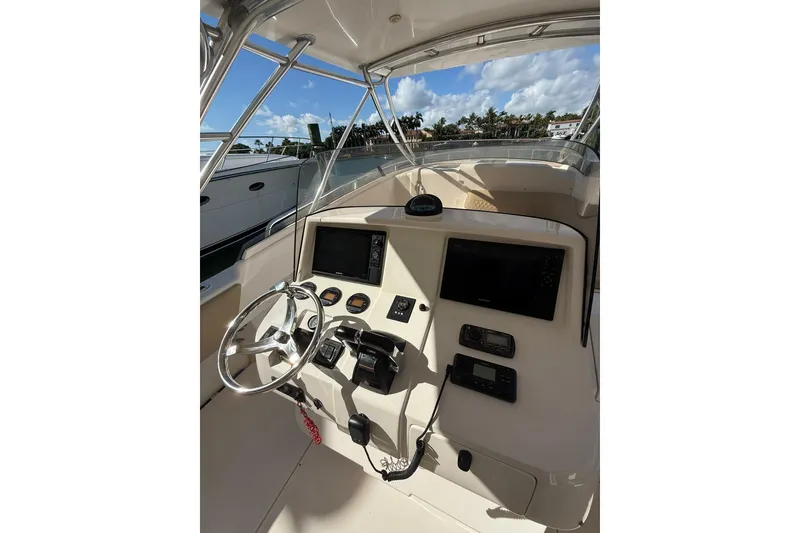 Slide: The Image of 2008 Intrepid 370 Cuddy boat docked under clear blue sky. - 24
