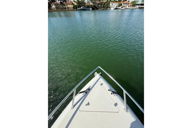 Slide: The Image of 2008 Intrepid 370 Cuddy boat interior with tan quilted seating. - 46