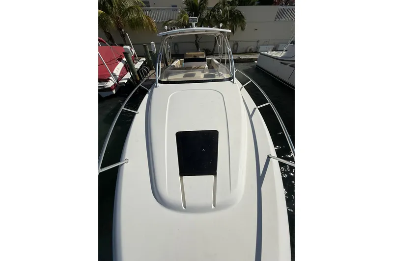 Slide: The Image of 2008 Intrepid 370 Cuddy boat interior with beige seating and palm trees in the background. - 47