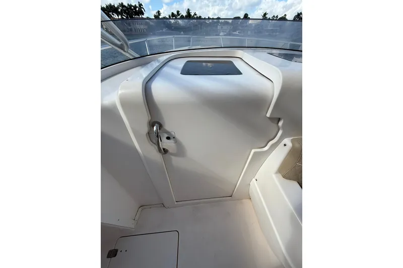 Slide: The Image of 2008 Intrepid 370 Cuddy boat docked, featuring sleek white deck and modern design. - 53