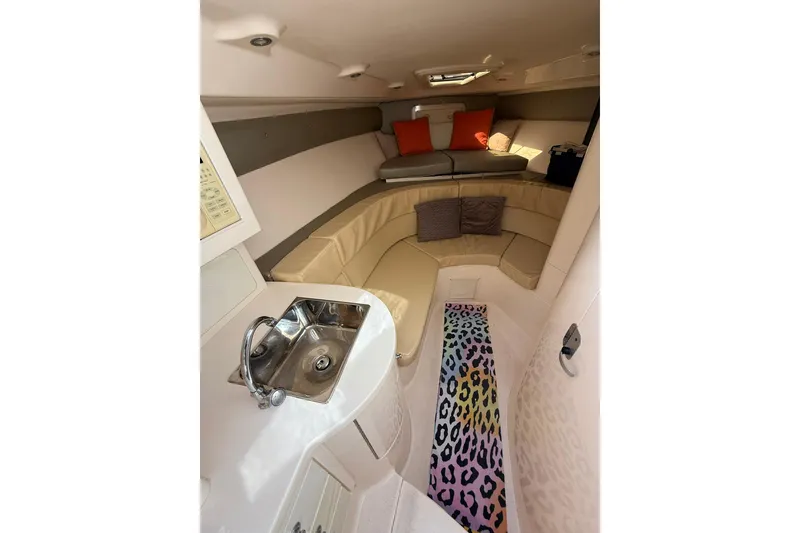 Slide: The Image of 2008 Intrepid 370 Cuddy boat docked near waterfront apartments and palm trees. - 56