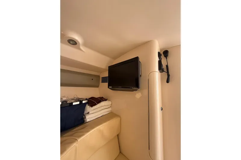 Slide: The Image of 2008 Intrepid 370 Cuddy cabin interior with open door, showcasing seating and storage. - 60