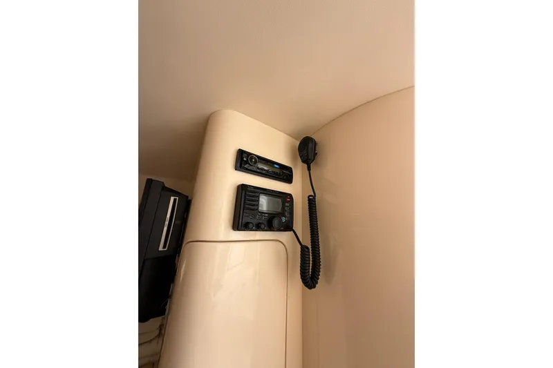 Slide: The Image of 2008 Intrepid 370 Cuddy interior with kitchenette, seating, and colorful rug. - 61