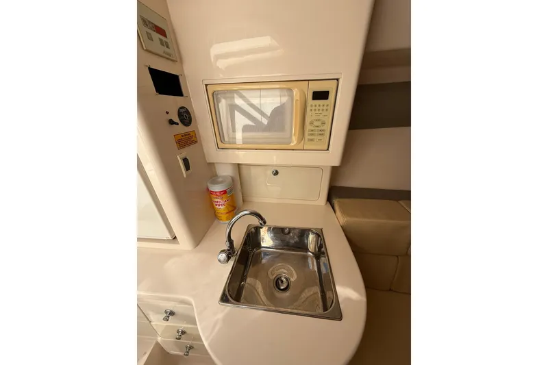 Slide: The Image of 2008 Intrepid 370 Cuddy interior with TV, radio, and neatly stacked towels. - 66