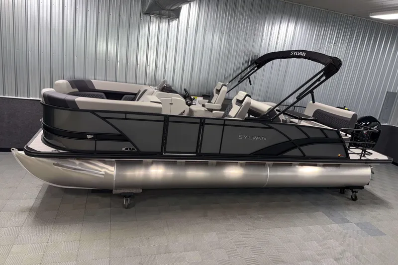 The Image of 2026 Sylvan L3 DLZ pontoon boat in showroom, featuring sleek design and modern seating. - 0