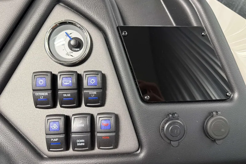Slide: The Image of Control panel of 2026 Sylvan L3 DLZ boat with switches and trim gauge. - 15