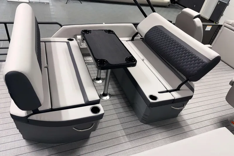 Slide: The Image of 2026 Sylvan L3 DLZ boat interior with gray seating and a central table. - 17