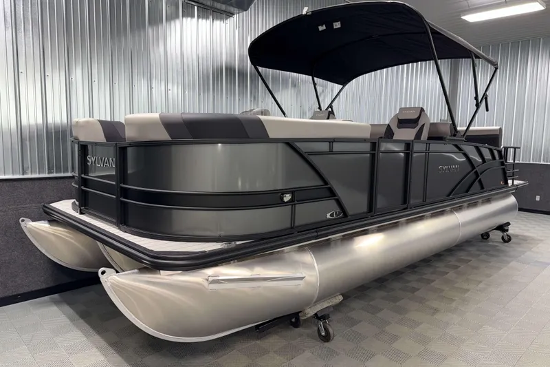 Slide: The Image of 2026 Sylvan L3 DLZ pontoon boat in a showroom with sleek design and canopy. - 21