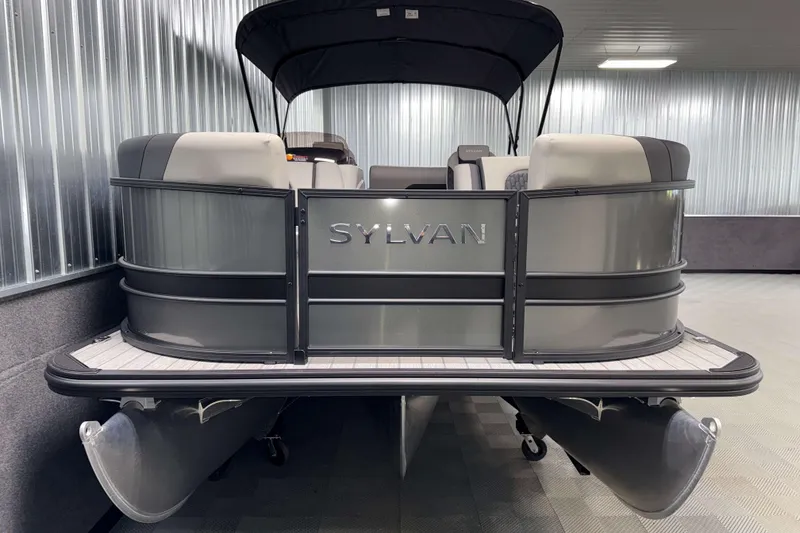 Slide: The Image of 2026 Sylvan L3 DLZ pontoon boat in a showroom, featuring sleek design and modern seating. - 22