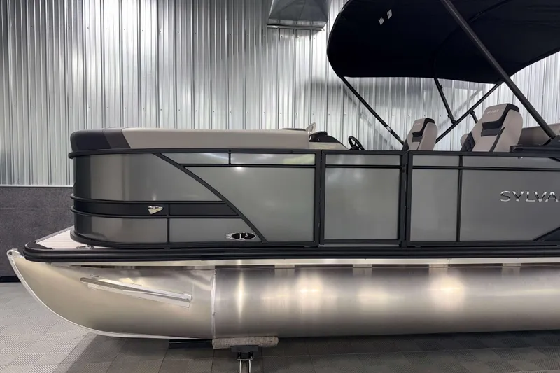 Slide: The Image of 2026 Sylvan L3 DLZ pontoon boat with sleek design in a showroom setting. - 23