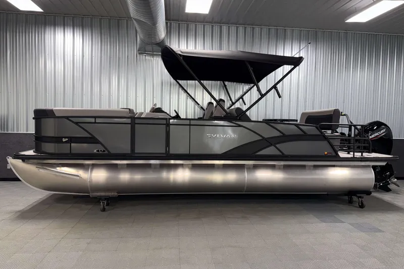 Slide: The Image of 2026 Sylvan L3 DLZ pontoon boat in a modern indoor showroom. - 24
