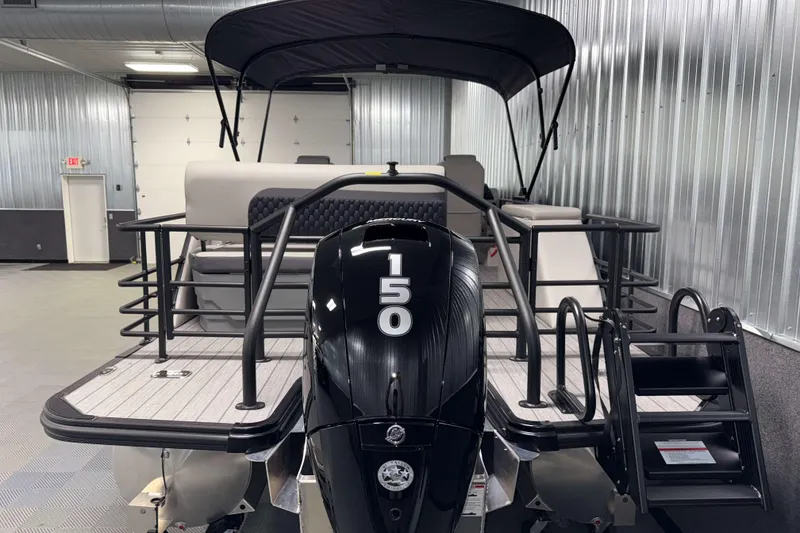 Slide: The Image of 2026 Sylvan L3 DLZ pontoon boat with 150 horsepower engine in a showroom. - 28