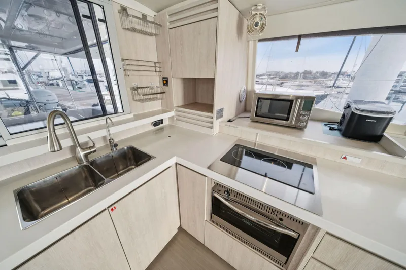 Slide: The Image of Modern kitchen in 2016 Leopard 48 yacht with appliances and marina view. - 102