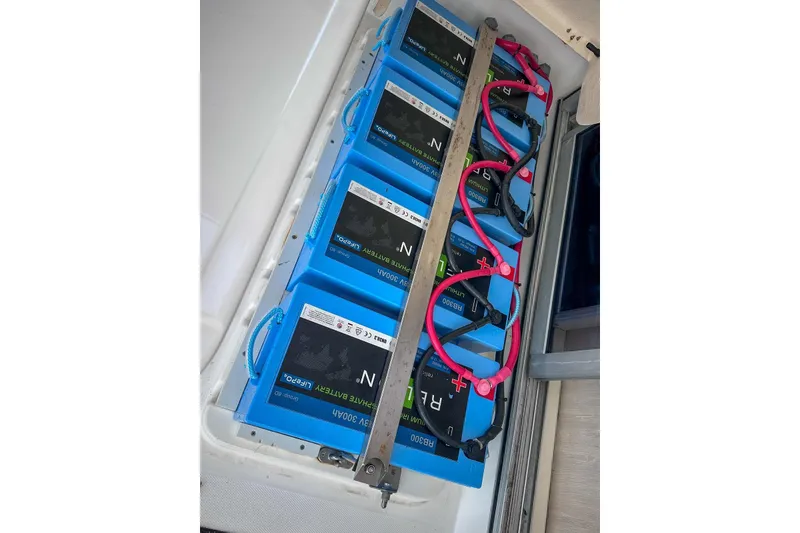 Slide: The Image of Battery compartment of a 2016 Leopard 48 yacht with multiple blue lithium batteries. - 109