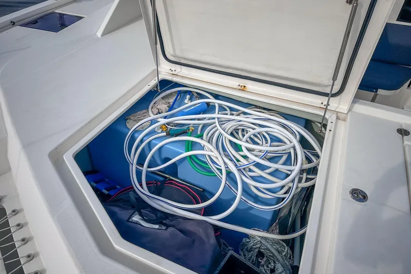 Slide: The Image of Open storage compartment on 2016 Leopard 48 yacht with coiled hoses and equipment. - 112