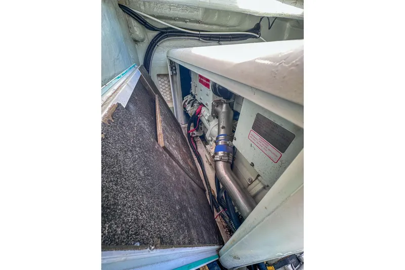 Slide: The Image of Engine compartment of a 2016 Leopard 48 yacht, showcasing mechanical components and wiring. - 114