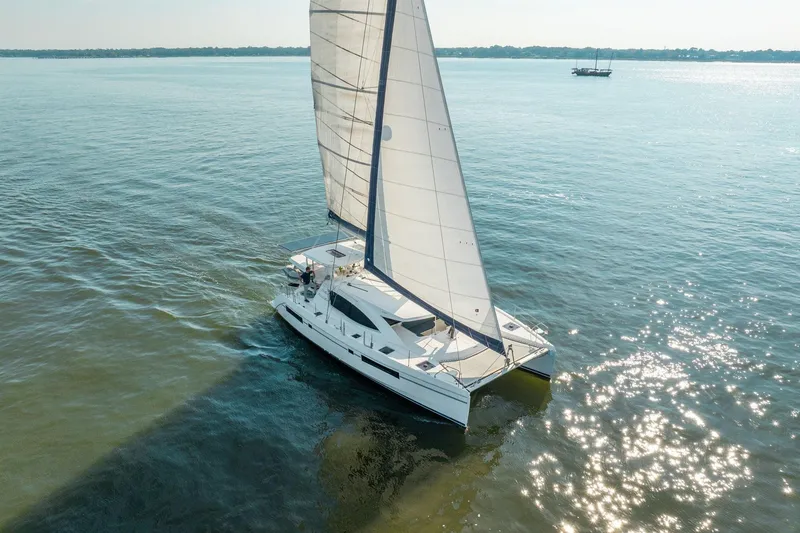 Slide: The Image of 2016 Leopard 48 catamaran sailing on calm waters under clear skies. - 12