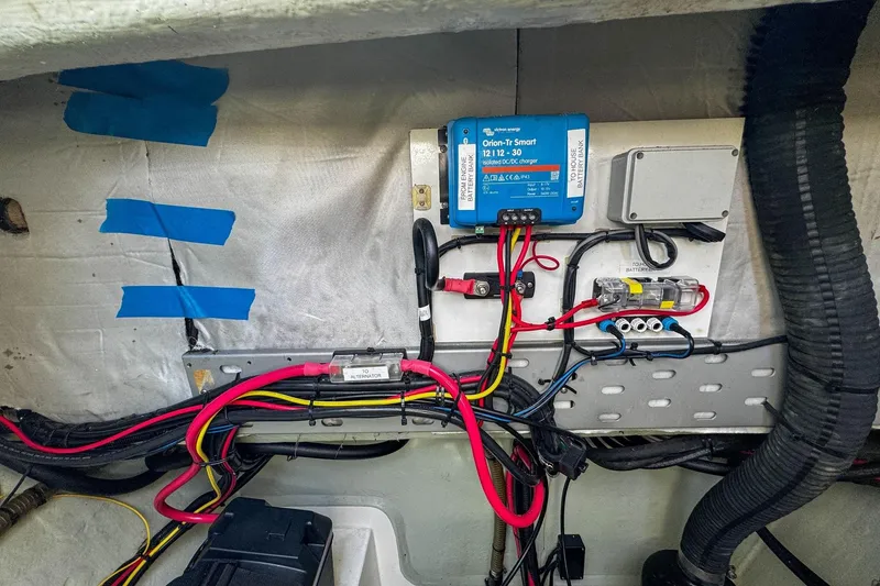 Slide: The Image of Electrical setup in a 2016 Leopard 48 yacht, featuring wiring and a Victron Energy charger. - 122
