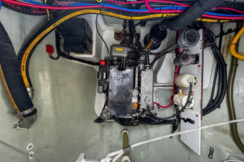 Slide: The Image of Engine compartment of a 2016 Leopard 48 yacht, showcasing wiring and mechanical components. - 124