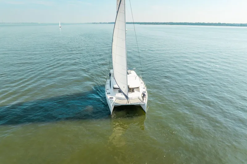 Slide: The Image of Sailing catamaran Leopard 48, 2016 model, gliding on calm waters under clear skies. - 13