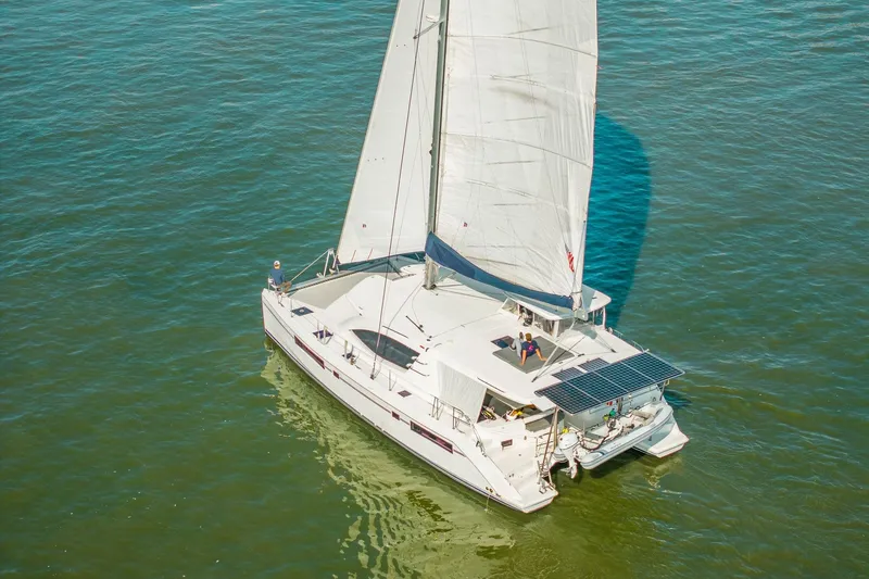 Slide: The Image of 2016 Leopard 48 sailboat cruising on open water with solar panels. - 14