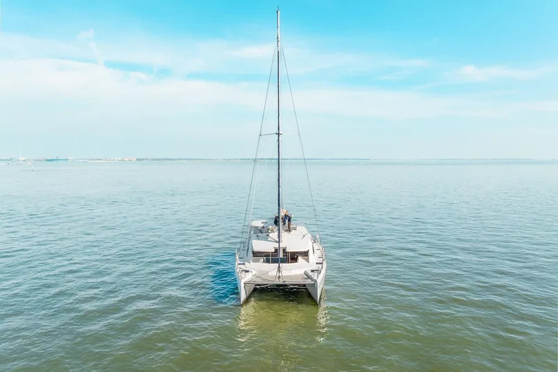 Slide: The Image of 2016 Leopard 48 catamaran sailing on calm blue waters under a clear sky. - 16