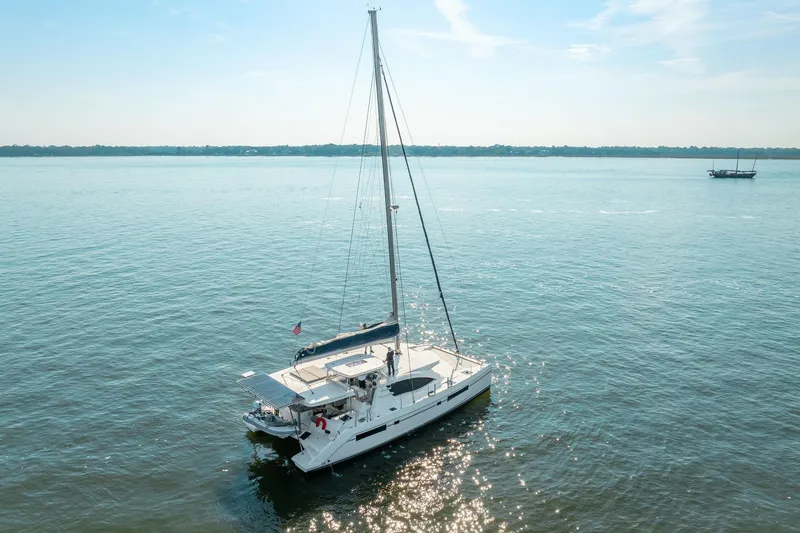 Slide: The Image of 2016 Leopard 48 catamaran sailing on calm waters under a clear blue sky. - 18