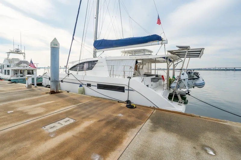 Slide: The Image of 2016 Leopard 48 catamaran docked at marina with American flag. - 22