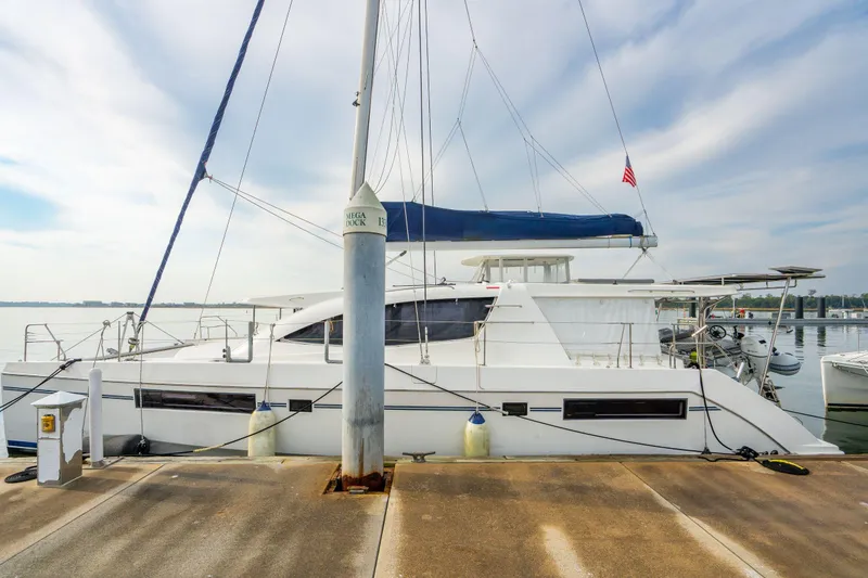 Slide: The Image of 2016 Leopard 48 catamaran docked at marina with clear sky background. - 23