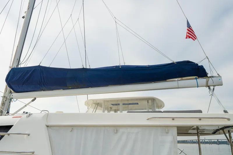 Slide: The Image of 2016 Leopard 48 sailboat with covered boom and American flag. - 28