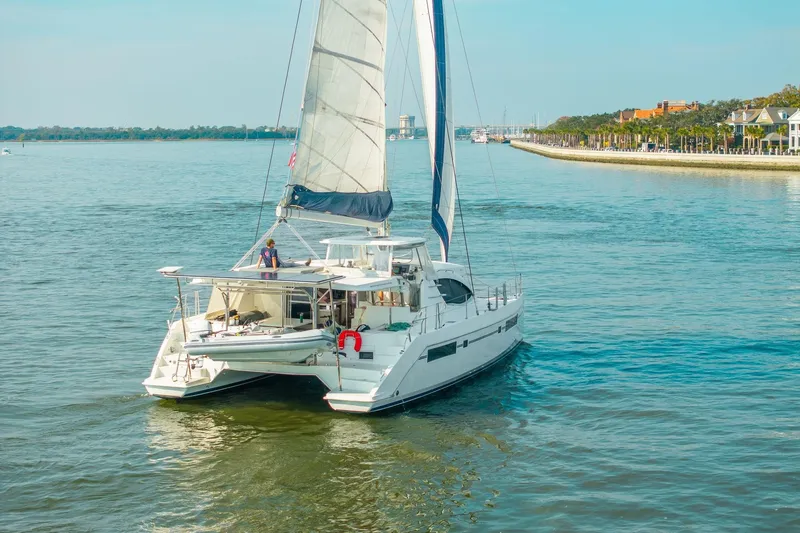 Slide: The Image of Sailing catamaran Leopard 48, 2016 model, cruising near a scenic coastline. - 3