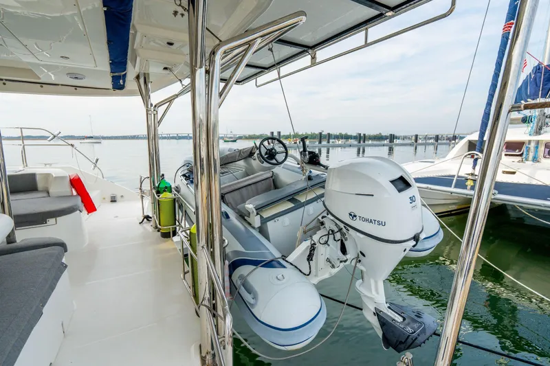 Slide: The Image of Leopard 48 yacht deck with Tohatsu motorboat, 2016 model, docked in marina. - 38