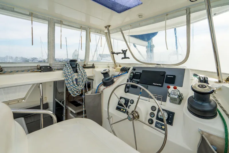 Slide: The Image of Helm of 2016 Leopard 48 yacht with navigation equipment and steering wheel. - 42