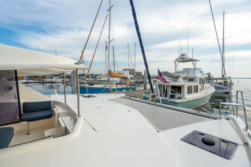 Slide: The Image of 2016 Leopard 48 yacht docked in a marina with other boats under a cloudy sky. - 56