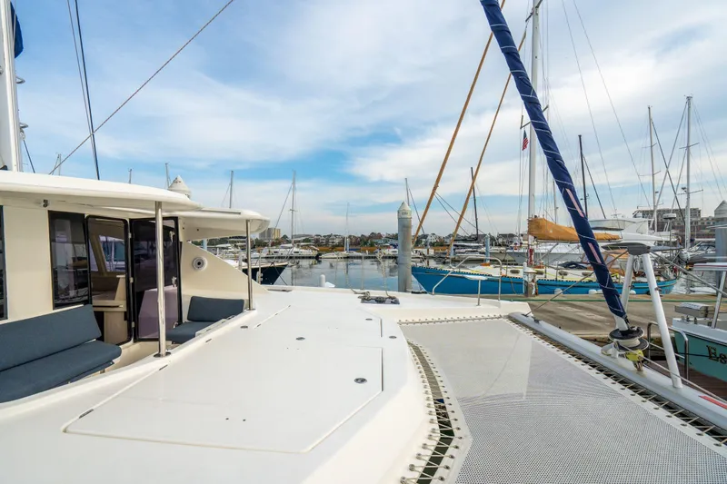 Slide: The Image of Leopard 48 catamaran docked at marina, showcasing spacious deck and modern design. - 57