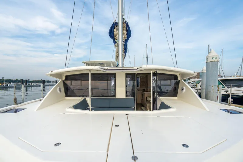 Slide: The Image of 2016 Leopard 48 catamaran docked at marina, showcasing spacious deck and modern design. - 59