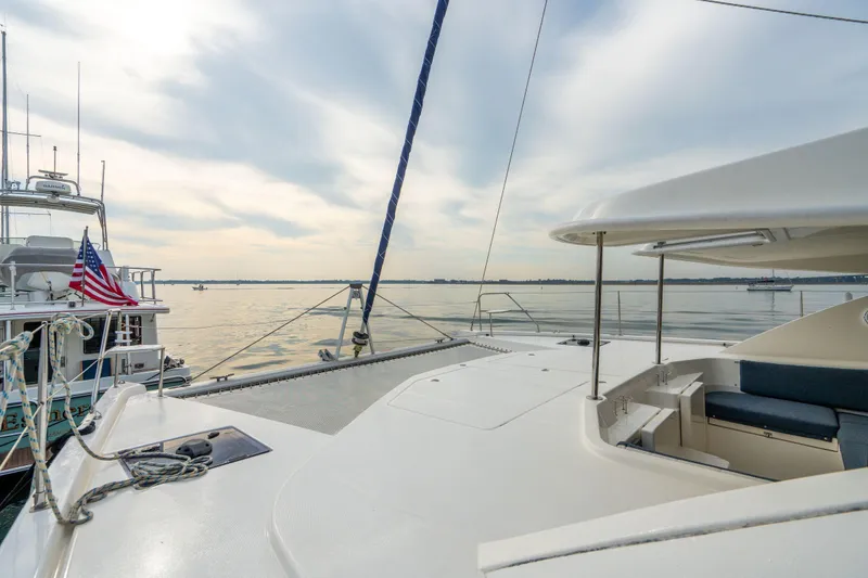 Slide: The Image of 2016 Leopard 48 yacht deck with serene ocean view and American flag. - 61