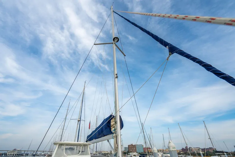 Slide: The Image of Sailboat mast of 2016 Leopard 48 against a clear blue sky in a marina. - 66