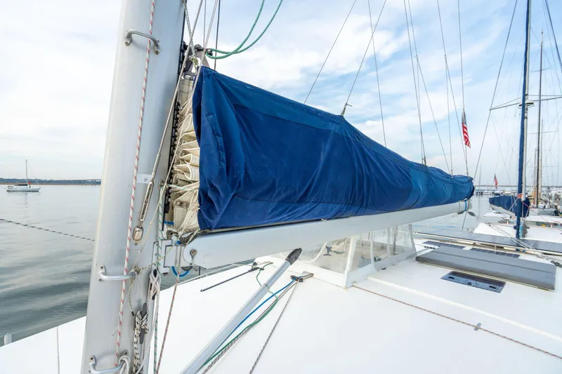 Slide: The Image of 2016 Leopard 48 sailboat with blue sail cover, docked in calm waters. - 71