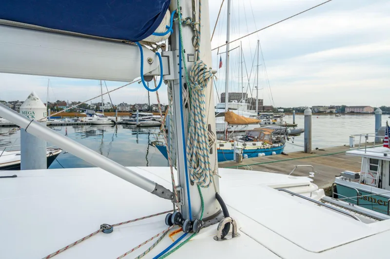 Slide: The Image of Sailboat deck view at marina, featuring Leopard 48, 2016 model, with moored boats in background. - 73