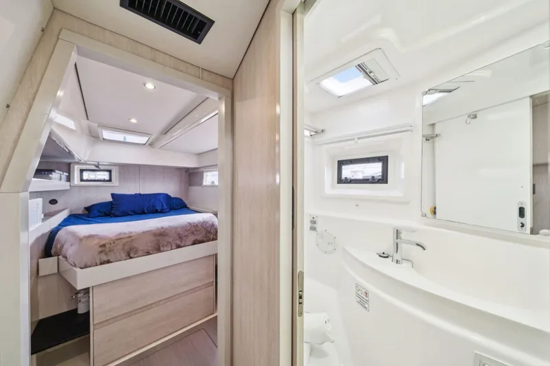 Slide: The Image of Luxurious interior of 2016 Leopard 48 yacht featuring cozy bedroom and modern bathroom. - 91