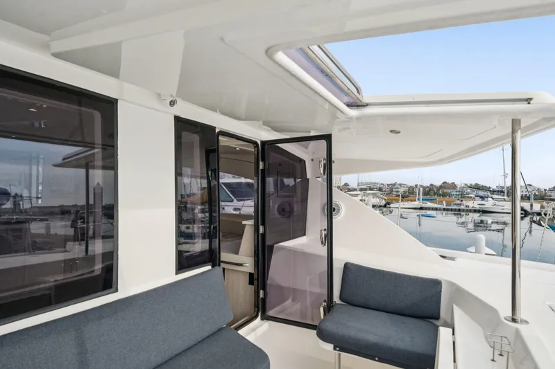 Slide: The Image of Leopard 48 catamaran interior, 2016 model, featuring spacious seating and marina view. - 98